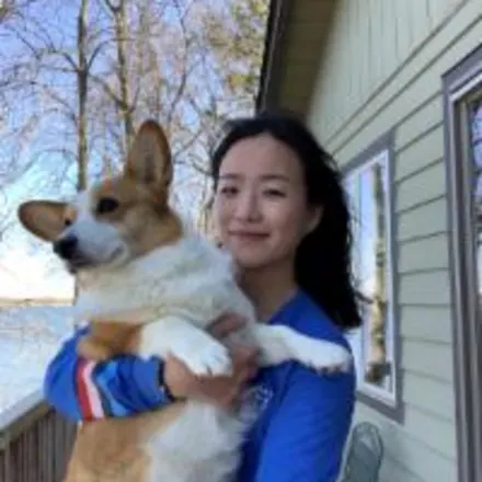 Dr. Kim holding a corgi dog